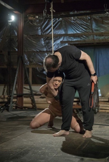 Dark haired slave Adelle Sabelle is tortured before being used for sex