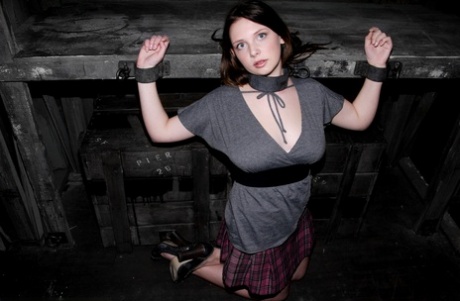 Barely legal Brazilian sub Sara Scott posing bound in the dungeon